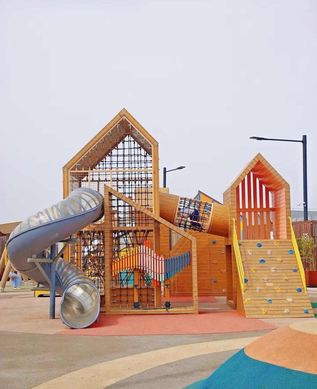 Timber play houses combination with spiral slide and climbing wall